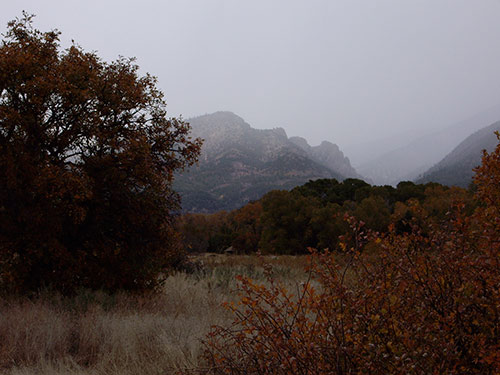 A photograph of a mountain that in silhouette looks like the profile of a woman singing.